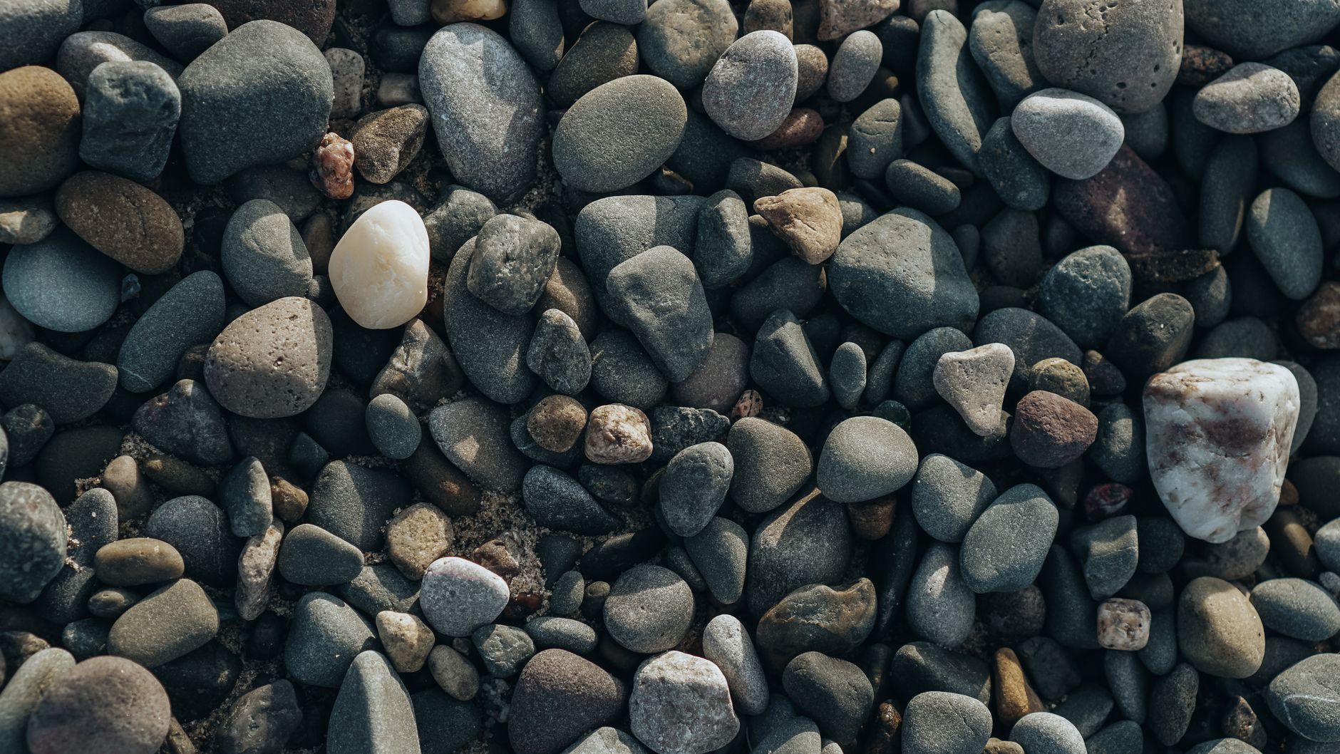 moody gritty texture of beach pebbles in close up